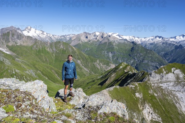 Mountaineer in front of mountain panorama with Großvenediger, mountain landscape with mountain peaks of the Venediger group, view from the summit of the Gösleswand, Lasörling group, Hohe Tauern National Park, East Tyrol, Tyrol, Austria, Europe