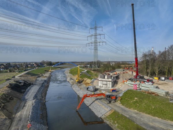 Dinslaken, Voerde, North Rhine-Westphalia, Germany - New Emscher estuary into the Rhine. New construction of the railway bridge and restoration of the dykes after dyke erosion during the 2023 flood. Renaturalisation of the Emscher. Flood protection through land expansion. The mouth of the Emscher into the Rhine was moved almost 500 metres north from Dinslaken to Voerde. Fish can now swim up the new Emscher from the Rhine through a newly created floodplain area without any barriers. Following the construction of a parallel sewer, the Emscher has been completely free of sewage since January 2022. The river was previously an open, above-ground combined sewer with rainwater and wastewater