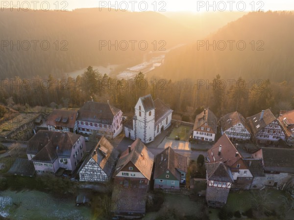Small village with church and half-timbered houses in a hilly landscape at sunrise, Zavelstein, district of Calw, Black Forest, Germany, Europe