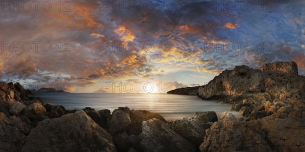 Dramatic sunset at the fishing village of Finiki by the sea with rocky coastline, Finiki, Karpathos, Greece, Europe