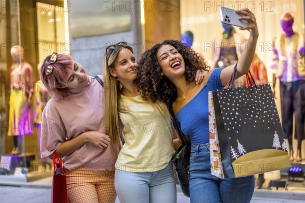 Three female multi-ethnic friends taking selfie shopping in a mall