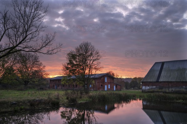 Morning atmosphere with sunrise, Othenstorf Estate with pond and animal stables, Othenstorf, Mecklenburg-Western Pomerania, Germany, Europe