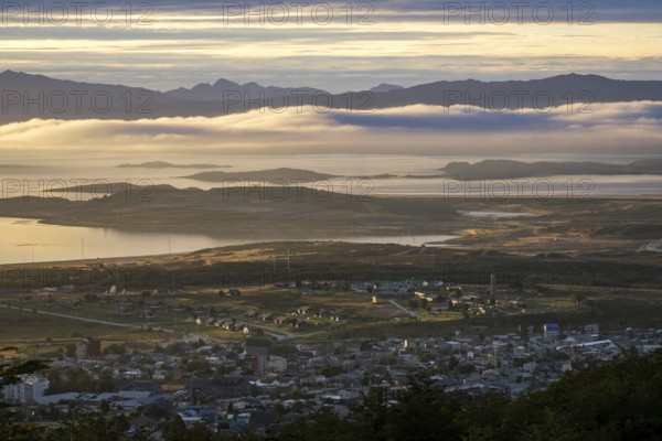 Ushuaia, Tierra del Fuego, Argentina, sunrise over the Beagle Channel, the Beagle Channel is a natural waterway at the southern tip of South America that connects the Atlantic Ocean with the Pacific Ocean. Ushuaia is the southernmost city in the world, the end of the world. Behind mountain range on the island of Navarino in Chile, Dientes de Navarino, South America