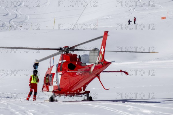 25 March 2024, Grindelwald, Switzerland: Rescue helicopter in action after a skiing accident