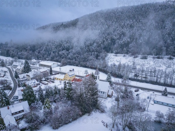 Village in the snow, bordered by fog and densely wooded hills, Enzklösterle, district of Calw, Black Forest, Germany, Europe