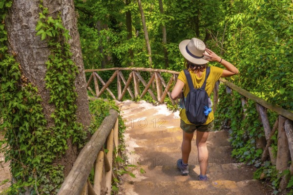 A female tourist walking down stairs in the Monasterio de Piedra Natural Park, Aragon