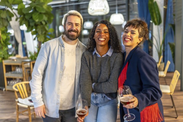 Happy multi-ethnic millennial and modern friends smiling standing at night party on the roof of a night bar