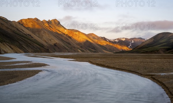 Rhyolite mountains and river Jökulgilskvísl, Landscape at Landmannalaugar, Dramatic volcanic landscape at sunset, Colourful erosion landscape with mountains, Landmannalaugar, Fjallabak Nature Reserve, Suðurland, Iceland, Europe