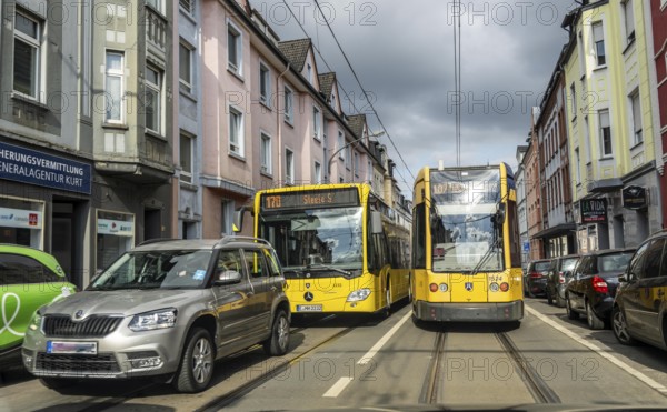 Tram and bus in traffic, on the street Schonnebeckhöfe in Essen-Katernberg, North Rhine-Westphalia, Germany, Europe