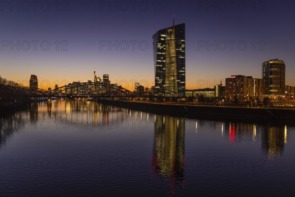 The lights in the offices of the European Central Bank (ECB) and the Frankfurt skyline glow in the evening after sunset, Osthafen, Frankfurt am Main, Hesse, Germany, Europe