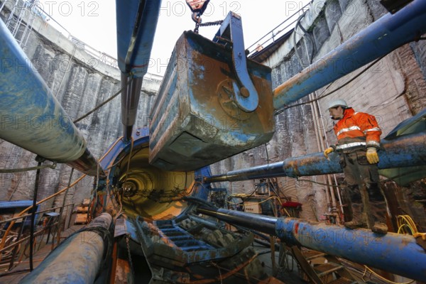 Emscher conversion theme photo, the Emscher system will be wastewater-free in 2021 - new construction of a sewer on the Boye, the second largest tributary of the Emscher, the excavated soil is lifted out of the shaft in a lorry during tunnelling, the Boye is renaturalised and transformed into a near-natural body of water, was previously an open, above-ground wastewater channel, mixed water channel with surface water and wastewater, the ecological conversion of the Emscher system consists of the construction of a central wastewater treatment system in the Ruhr area, the construction of sewers and the renaturalisation of the Emscher and its tributaries, archive photo from 13.11.2014, Bottrop, Ruhr area, North Rhine-Westphalia, Germany, Europe
