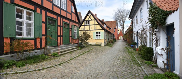 Alley with cobblestones and historic half-timbered houses at the Heiliggeistkloster, Stralsund, Mecklenburg-Vorpommern, Germany, Europe