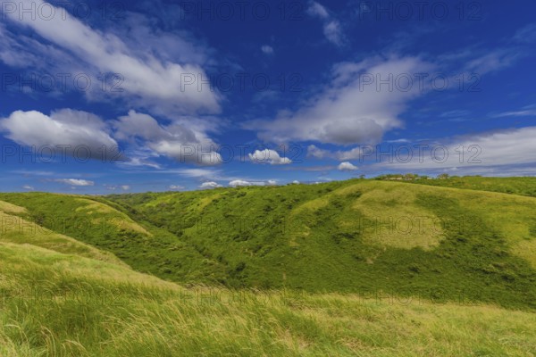 Beautiful landscape of green hills with clouds and blue sky. Panoramic viewpoint EL CRUCERO overlooking the green hills