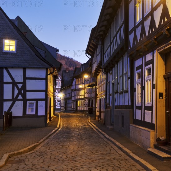 Narrow alley with half-timbered houses and cobblestones in the old town centre in the evening, UNESCO World Heritage Site, Goslar, Lower Saxony, Germany, Europe