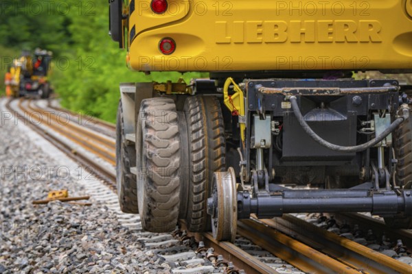 Close-up of the tyres of a yellow construction machine on rails, track construction, Hermann Hessebahn, Calw, Black Forest, Germany, Europe