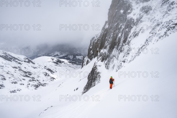 Ski tourer on a steep mountain slope, Snowy mountain landscape, Bernese Alps, Bernese Oberland, Switzerland, Europe