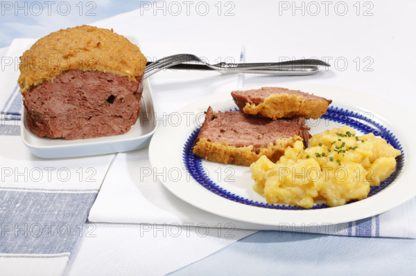 Swabian cuisine, Stuttgarter Leberkäs in a horseradish-mustard coating, Swabian potato salad, Leberkäse, meat loaf, mustard crust, grandmother's cooking, regional, home cooking, serving platter, plate, cutlery, typical Swabian, traditional cuisine, food photography, studio, Germany, Europe