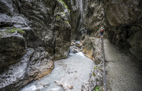 Hammersbach mountain stream in a canyon, mountaineer on a hiking trail in a gorge, Höllentalklamm, Höllental, Bavaria, Germany, Europe