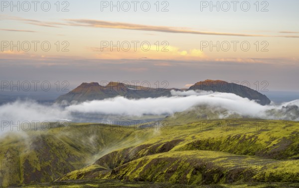 Fog between mountains, moss-covered volcanic mountain landscape, at sunset, Pakgil, Iceland, Europe