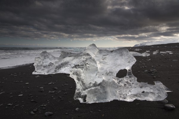 Little icebergs and crushed ice on the black beach at Joekulsarlon glacial lake