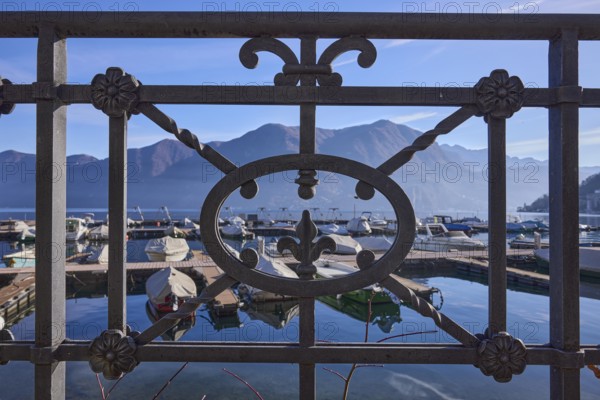 Forged railing, close-up, backlight, lake, mountains, haze, marina, depth of field, Lake Lugano, Lugano, district of Lugano, canton of Ticino, Switzerland, Europe