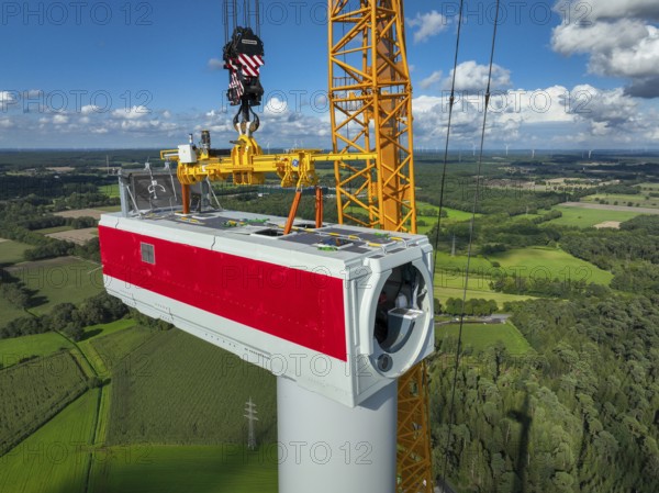 Dorsten, North Rhine-Westphalia, Germany, construction of a wind turbine, the first wind turbine of the Große Heide wind farm. A large mobile crane places the nacelle, the nacelle on the tower, Europe