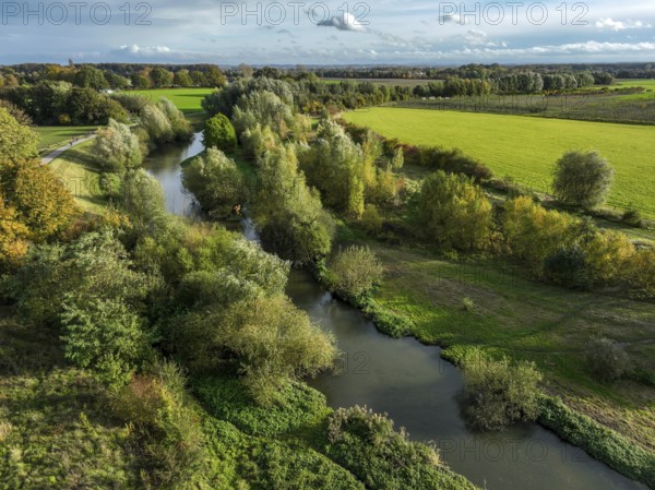 Bergkamen, Ruhr area, North Rhine-Westphalia, Germany, autumn landscape on the Seseke. The renaturalised Seseke, a tributary of the Lippe, has been transformed into a near-natural watercourse, flood protection and biodiversity through newly designed floodplains. Following the construction of a parallel sewer, the Seseke is now free of wastewater, having previously been an open, above-ground wastewater sewer, combined sewer with surface water and wastewater. Theme photo: EU Nature Conservation Act. The EU Nature Conservation Act obliges member states to implement measures to restore nature on at least 20 per cent of the EU's land and sea areas by 2030, Europe