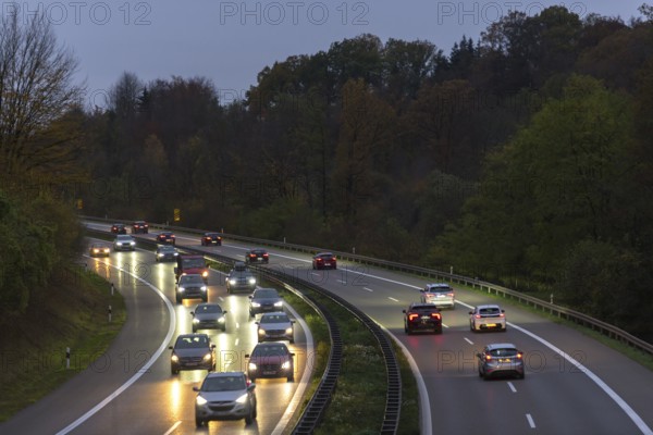 Traffic on a motorway at night surrounded by forests and illuminated by headlights, Rems-Murr district, Baden-Württemberg, Germany, Europe