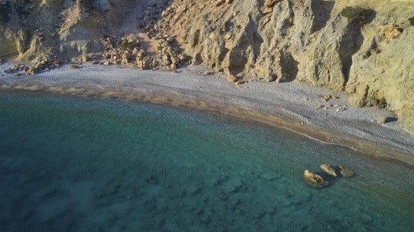 Quiet stretch of beach with rocky coastline and crystal clear water in turquoise blue colour, drone shot, evening light, Araki Beach, southwest coast, Karpathos, Dodecanese, Greek Islands, Greece, Europe