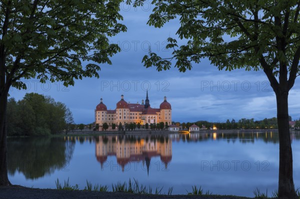 Moritzburg Hunting Lodge with reflection in the castle pond in the evening, Moritzburg, Saxony, Germany, Europe