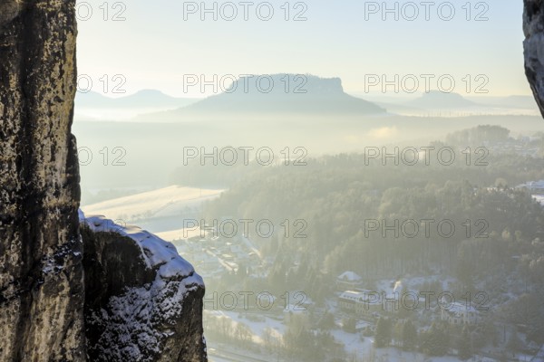 View from the Bastei bridge into the misty Elbe valley with the spa town of Rathen and Lilienstein, Saxon Switzerland, Saxony, Germany, Europe