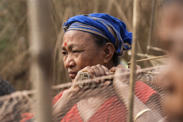 Villagers participate in a community fishing event on the occasion of the Bhogali Bihu festival at Panbari village in Assam on 13 January 2025. Magh Bihu, also known as Bhogali Bihu, is one of the most vibrant festivals celebrated in Assam and other parts of Northeast India