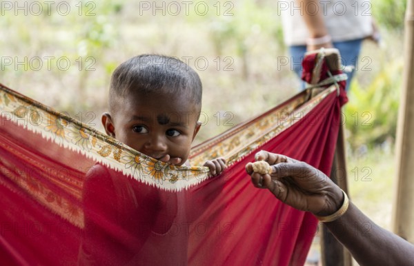Children of tea plantation workers takes care by daycare worker underneath a tent as their mothers pluck tea leaves at the Tea Estate on April 2, 2025 in Bansbari, Assam, India, Asia