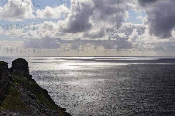 Rocky coast with a view of the sea under dramatic clouds, Cliffs of Moher