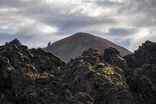 Lava field in front of colourful rhyolite mountain Brennisteinsalda, volcanic landscape, erosion landscape, Landmannalaugar, Fjallabak Nature Reserve, Icelandic Highlands, Suðurland, Iceland, Europe