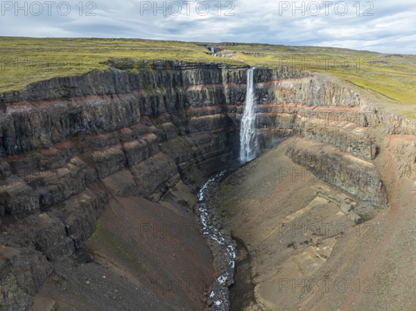 Waterfall Hengifoss, basaltic layers interwoven with red sedimentary layers, aerial view, Iceland, Europe