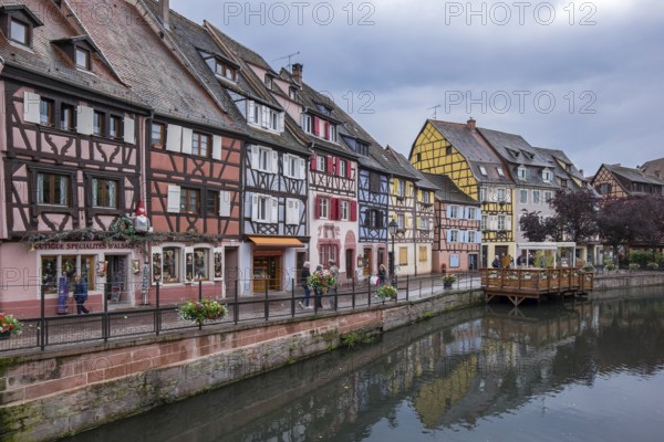 Colourful half-timbered houses on a quiet canal in a historic old town with a cloudy sky, Petite Venise, Little Venice, half-timbered houses on the banks of the Lauch, old town of Colmar, Haut-Rhin department, European entity Alsace, France, Europe
