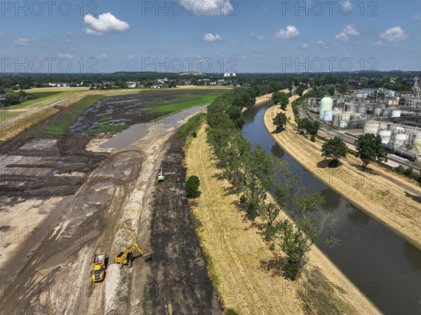 Oberhausen, North Rhine-Westphalia, Germany, renaturalisation of the Emscher in the Holtener Bruch. OQ Chemicals plant Ruhrchemie on the right. The currently straightened Emscher, shown here at flood level, has been given curves again and can meander through its new floodplain. The ecological conversion of the Emscher system consists of the construction of a centralised wastewater treatment system in the Ruhr region, the construction of sewers and the renaturation of the Emscher and its tributaries. Following the construction of a parallel sewer, the Emscher has been completely free of sewage since January 2022. The river was previously an open, above-ground combined sewer with rainwater and wastewater, Europe