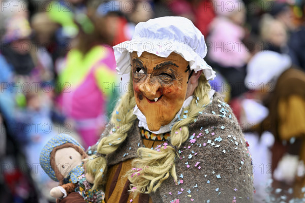 Person masked as a grandmother at the carnival parade of the Wey guild on Rose Monday, Güdismäntig, Lucerne Carnival 2024, Lucerne, Switzerland, Europe
