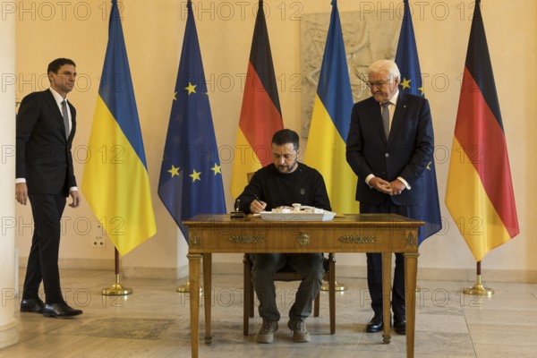 Volodymyr Selensky (President of Ukraine) signs the guest book with Frank-Walter Steinmeier (President of the Federal Republic of Germany) at Bellevue Palace, 11 October 2024