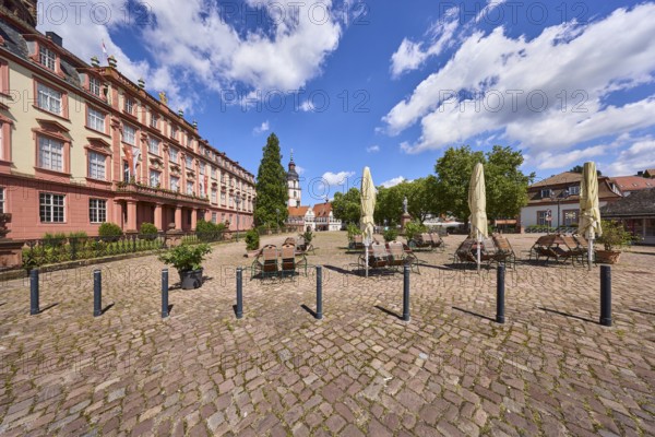 Erbach Castle, outdoor area of a restaurant with tables, chairs and parasol, bollards, trees, church tower, Erbach town church, blue sky with cumulus clouds, market square, Erbach, Odenwald, Odenwaldkreis, Hesse, Germany, Europe