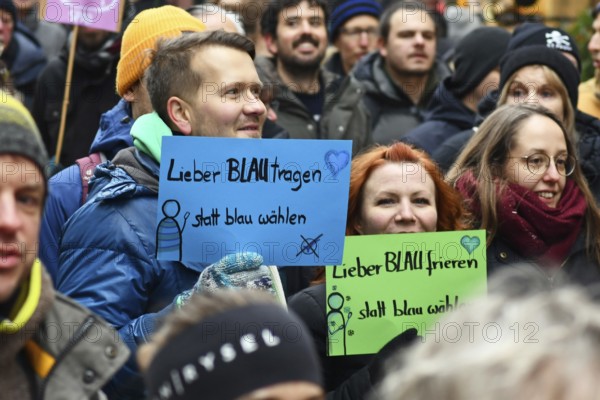 Heidelberg, Germany - February 12th 2025: Person holding up sign saying 'I'd rather wear blue than vote blue' in crowd at protest against far-right