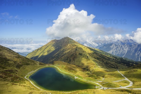 Artificially created lake, snow pond, feeds the snow cannons that completely cover the slopes of the Fellhorn and Kanzelwand cable cars with snow, behind it the Fellhorn, 2038m, Allgäu Alps, Bavaria, Germany, Europe