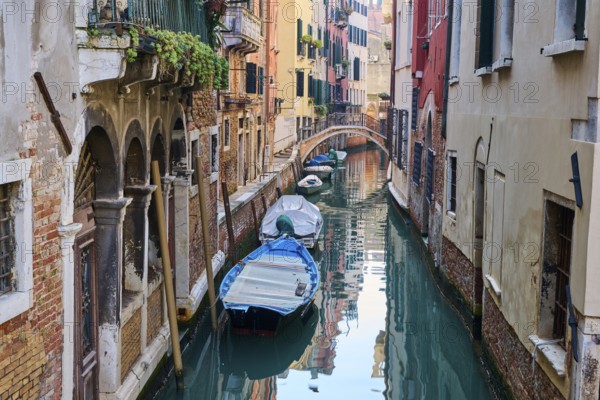 View on a waterway with boats lying in the water in Venice on a sunny day in winter, Italy, Europe
