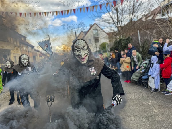 Hofener Hogamale with smoke bomb at the big carnival parade of the Hofener Scillamännle, Hofen, Stuttgart, Baden-Württemberg, Germany, Europe