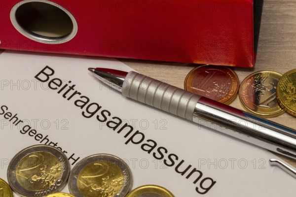 Symbolic image of contribution increase: cover letter, euro coins, biros and folder