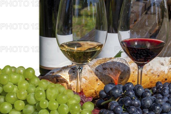 Symbolic image of grape grape harvest: Ripe grapes decorated with wine glasses on a wooden table