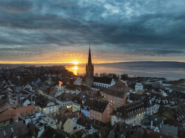 Aerial view of an atmospheric sunrise over the town of Radolfzell on Lake Constance with the cathedral tower, district of Constance, Baden-Württemberg, Germany, Europe