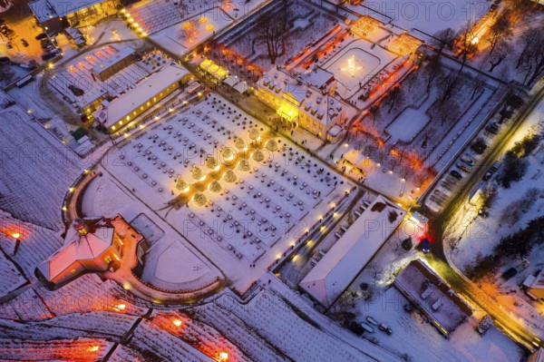 Aerial view of Wackerbarth Castle with castle park, belvedere and vineyards with snow and Christmas lights, Radebeul, Saxony, Germany, Europe