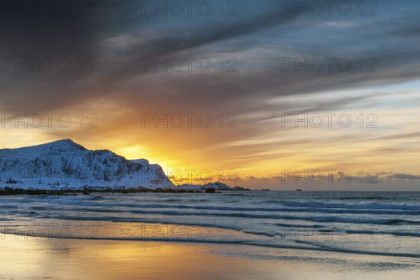Sunset in winter at Skagsanden, stones on the beach at Flakstad, Flakstadøy, Lofoten, Nordland, Norway, Europe